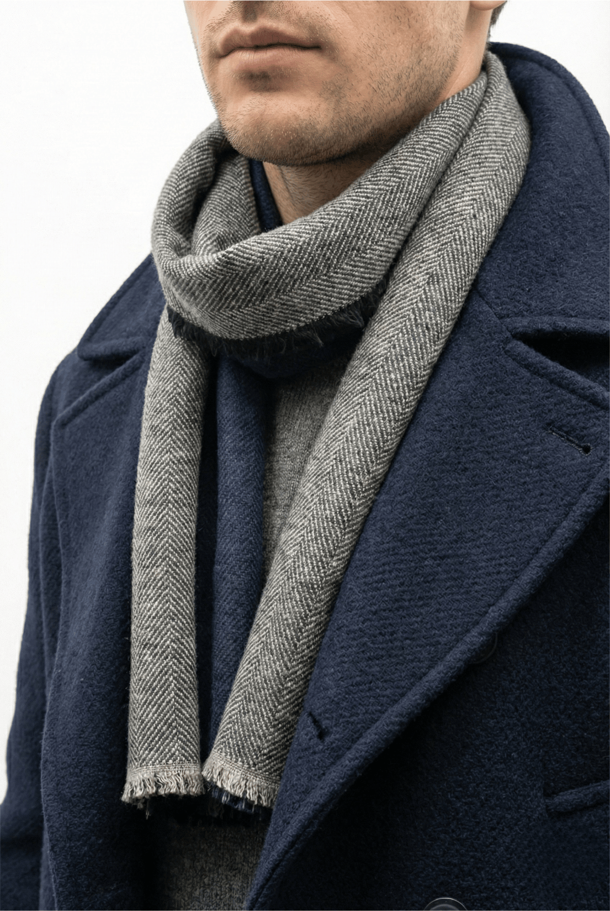 Écharpe à rayures grises et anthracite portée avec un manteau bleu marine