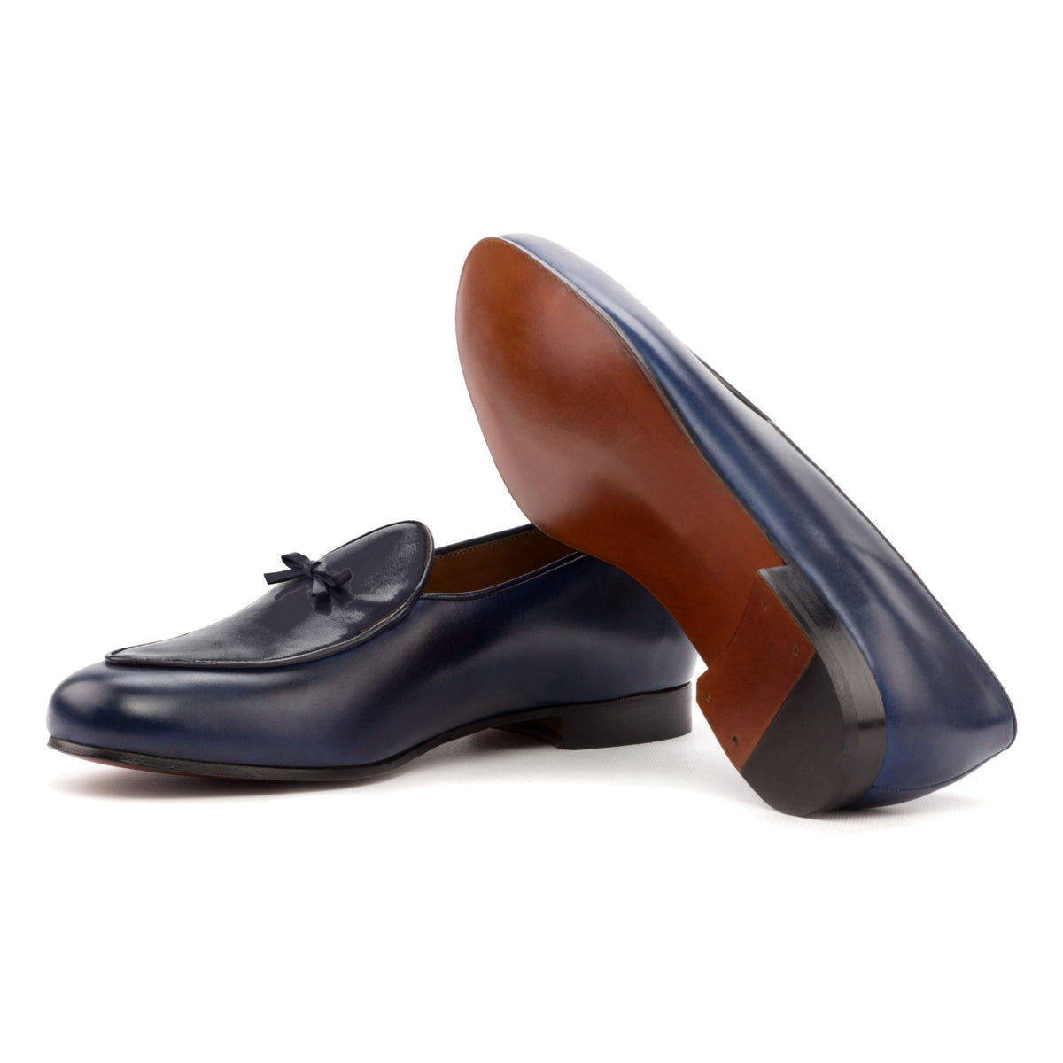 Mocassin belge en cuir teinté main bleu pétrole : une chaussure couchée montre la semelle