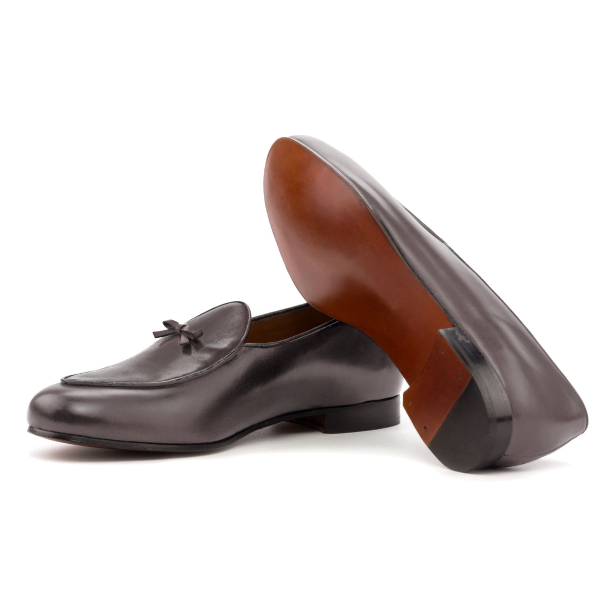 Mocassin belge en cuir teinté main marron foncé : une chaussure couchée montre la semelle